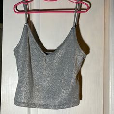 Forever 21 Women’s Silver Sparkly Top Size: Medium 68% Polyester, 16% Rayon, 13% Metallic Yarn, 3% Spandex/Elastane Condition: Never Used, Very Good Condition Casual Party Tops With Built-in Bra, Casual Party Crop Top With Built-in Bra, Glamorous Tops With Built-in Bra, Casual Party Crop Top Tank Top, Casual Crop Top Tank Top For Party, Glamorous V-neck Crop Top For Spring, Forever 21 Sleeveless Crop Top For Party, Forever 21 Sleeveless Party Crop Top, Forever 21 Sleeveless Crop Top For Night Out