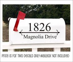 a white mailbox with the words magnalia drive on it and a red flag sticking out of it