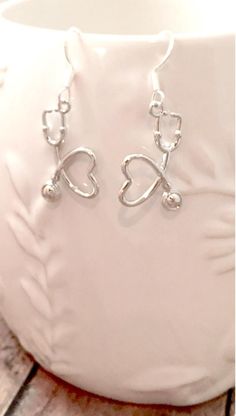 Nice stethoscope earrings! The silver plated fishhook ear wires measure 3/4" x 7/10", and the zinc alloy stethoscope charms measure 7/8" x 5/8" (Total length is approximately 1 3/5") All items are lead and nickel free, message with any questions, thanks! Silver Heart Dangle Earrings, Adjustable Silver Surgical Steel Jewelry, Adjustable Hypoallergenic Surgical Steel Jewelry, Hypoallergenic Adjustable Surgical Steel Jewelry, Adjustable Dangle Heart Earrings With Ear Wire, Adjustable Silver Sterling Heart Earrings, Adjustable Silver Dangle Heart Earrings, Hypoallergenic Round Surgical Steel Earrings, Hypoallergenic Surgical Steel Earrings