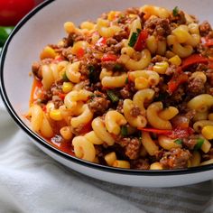 a white bowl filled with pasta and meat