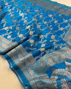 This is a very beautiful high quality mashru silk saree . All over zari motifs design with border . Saree length - 5.5 mtr. Blouse - 1 mtr. Dry clean only . Please note - color may be vary a little due to sunlight and photography . Please message us after purchasing in case you want fall and Pico done it not . No extra charges for fall and Pico but inform us . Blouse stitching is also available . Designer Blue Katan Silk Saree, Blue Katan Silk Saree For Eid, Designer Blue Saree With Traditional Patterns, Eid Blue Katan Silk Saree, Designer Paithani Silk Dupatta With Traditional Patterns, Dola Silk Saree With Traditional Patterns, Traditional Dola Silk Saree With Patterns, Traditional Drape Dola Silk Saree With Patterns, Paithani Silk Dupatta With Traditional Patterns