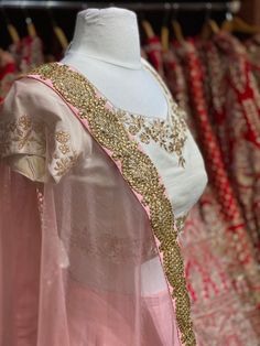 Dusky peach heavy kundan border lehenga with contrasting pearl white floral zardozi embroidery blouse and net border dupatta. Fabric: Raw Silk This outfit can be customized in multiple colors and specific to client measurements. 90 days of production time is required and are for bulk orders only! Orders are processed in store only! Final fittings/alterations not included. Minimum Order Quantity- 4 pieces Peach Wedding Sets With Sheer Dupatta, Traditional Peach Lehenga With Sheer Dupatta, Peach Choli With Sheer Dupatta For Reception, Embroidered Anarkali Choli In Peach, Embroidered Peach Lehenga With Traditional Drape, Peach Lehenga With Resham Embroidery In Traditional Drape, Peach Resham Embroidery Sharara For Wedding, Semi-stitched Peach Choli With Sheer Dupatta, Peach Sharara With Resham Embroidery For Wedding