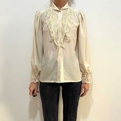 1970's or 80's Ted Lapidus rayon lace Victorian blouse.  Perfect boho elegance.  Very talitha Getty in Morocco.  The fabric feels like a fine rayon, a little bit silky but I think it may have some poly in it. Slightly sheer.  Nylon lace.  High lace neck.  Blouse is cut straight with no darts. Gathers at the shoulders for fullness.  Also gathers at the sleeve caps for a full sleeve.  Five plastic buttons up the front.  Elastic at the sleeve cuff.  Label Ted Lapidus Diffusion. Made in France. No content label, feels like a poly rayon mix, has a nice touch. Lace is nylon.  Dry clean only. Iron low heat.  Good vintage condition with no fabric or sewing flaws.  Measurements Shoulders 40cm/ 13inches Chest 110cm/ 43inches Waist 110cm/ 43inches Shoulder to hem 65cm/ 25inches Sleeve length 64cm/ 25 Vintage Blouse With Lace Sleeves, Spring Vintage Lace Top With Lace Trim, Vintage Lace Top With Lace Trim For Spring, Vintage Fashion Blouse With Lace Trim, Vintage Lace Trim Blouse, Vintage Lace Trim Blouse For Vintage Fashion, Vintage Lace Patchwork Top For Spring, Vintage Blouse With Lace Trim For Vintage Fashion, Vintage Lace Top Blouse