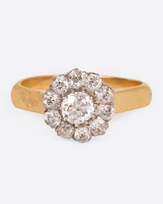 A wide yellow gold band with an old European cut diamond at its center, surrounded by a halo of smaller diamonds. Made of 14k yellow and white goldDiamonds Dimensions Size - 6.5Center diamond - 5mm diameter, G-VS2, 0.35ctBand - 3.5mmOverall face of ring - 10mm Made by Vintage sourced by Love Adorned founder Lori Leven Diamond Flower Ring, Flower Diamond Ring, Floral Engagement Ring, Put A Ring On It, European Cut Diamonds, Diamond Flower, Abalone Shell, Flower Ring, Vintage Diamond