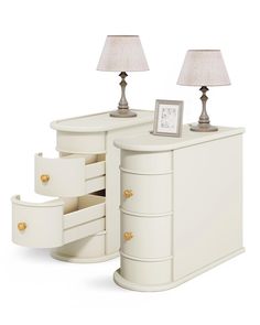 a white dresser with two lamps and a clock on it's side table next to a lamp shade