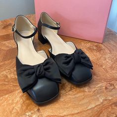 Product Description: Sophisticated Mary Jane Showcasing A Modern Square Toe With A Contrast Bow And A Dainty Ankle Strap With A Buckle Closure. 1.76'' Heel Buckle Closure Man-Made Upper Man-Made Lining Man-Made Footbed Man-Made Midsole Man-Made Sole Imported Black Low Heel Spring Heels, Black Low Heel Heels For Spring, Black Heels For Office Spring Season, Black Office Heels For Spring, Chic Black Heels With Bow, Chic Black Low Heel Heels, Black Bow Heels For Work, Chic Black Heels For Spring, Black Formal Heels For Spring