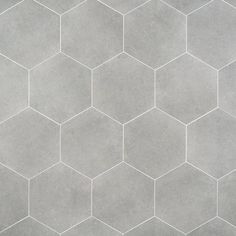 a tile floor with hexagonal tiles in grey and white colors on the top