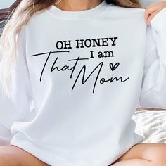 Oh Honey I Am That Mom, Funny Mom Sweatshirt, Cute Mom Sweat, Comfort Mama Sweat, I Am That Mom, Honey Life Mama Sweat, I Am That Mom Sweat, 🌟 Welcome to Charm Bees Tee! 🌸 DETAILS 🌸 Explore our carefully crafted sweatshirts and hoodies, designed for lasting durability with double-needle stitching. Enjoy the cozy, unisex design made from a blend of 50% cotton and 50% polyester for ultimate comfort. 🌸 HOW TO ORDER YOUR T-SHIRT 🌸 📸 Explore our captivating product photos. 🎨 Select your preferred style and color from the dropdown menus. ✍️ Personalize it with your chosen text color. 🔢 Indicate the desired quantity. 🛒 Click ADD TO CART and proceed with your purchase. Your customized shirt ships within 1 business day. Please anticipate potential delays during holidays. 🌸 CARE INSTRUCTIO White Tops With Lettering For Mother's Day, Oh Honey, Mom Funny, Sweatshirt Cute, Sweatshirts And Hoodies, Funny Mom, Mom Sweatshirt, Product Photos, Mom Humor