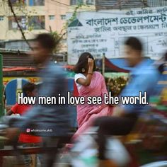 a woman in a pink sari is talking on her cell phone while people are walking by