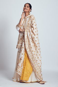 Daisy ivory straight short kurta with placement gota patti and dabka zardozi worked floral motifs. Comes with gharara and jaal pattern dupatta enhanced with mustard pure banarasi booti fabric at the back.
Component: 3
Embroidered
Neckline: Round
Sleeve Length: Three Quarter
Fabric: Kurta and Dupatta: Chanderi silk; Gharara: Georgette; Banarasi
Color: White
Button placket
Side slits
 - Aza Fashions Unstitched Off White Sharara With Resham Embroidery, Off White Sharara With Dabka Work In Traditional Drape, Off White Dabka Work Sharara With Traditional Drape, Off White Sharara With Zari Work And Straight Kurta, Off White Palazzo Saree Set For Eid, Off White Sharara With Dabka Work For Wedding, Wedding Off-white Sharara With Dabka Work, Unstitched Off White Sharara For Eid, Off White Traditional Drape Sets With Gota Work