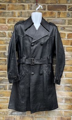 "KINGLOUIEVINTAGE   Quality Vintage & British made clothing DESCRIPTION = Vintage of London Top quality double breasted belted leather overcoat. Large retro notched collar with six button double breasted front opening. Buttoned epulates, half leather belt cuffs and matching waist belt. Two open slanting side pockets with single rear vent and lovely bronze lining inside.  Stunning garment in mint condition BRAND = Willerby SIZE (UK) = 38 CONDITION :- = Excellent, Practically unworn MEASURMENTS (I Classic Leather Jacket With Double-breasted Button, Classic Double-breasted Belted Outerwear, Classic Long Coat Leather Jacket With Belt, Classic Long Belted Leather Jacket, Classic Belted Long Leather Jacket, Double-breasted Belted Leather Jacket For Winter, Classic Winter Leather Jacket With Belt, Vintage Belted Outerwear For Formal Occasions, Belted Vintage Outerwear For Formal Occasions