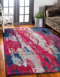 a living room area with a couch, chair and rug