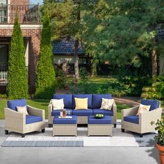 an outdoor patio furniture set with blue cushions