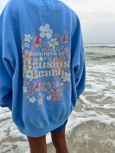 "Customizable Back design. If you want the back design to say \"The Summer I turned Pretty\" message me before ordering. Same price for custom back design.  Summers in Cousins Beach crewnecks. Oversized/unisex fit. Comes in three color options: White, blue, or pink. Front of sweatshirt has small print on the corner that says \"Team Conrad\" with a cute little sail boat design to represent Conrad as a sail instructor. The back has various flowers and the text \"Summers in Cousins Beach\"  in a pa Blue Crew Neck Sweatshirt For Summer, Blue Graphic Print Summer Sweatshirt, Blue Graphic Print Sweatshirt For Summer, Beach Cotton Crew Neck Sweatshirt, Blue Relaxed Fit Sweatshirt For Beach Season, Vsco Style Crew Neck Sweatshirt For Summer, Beach Season Sweatshirt With Letter Print, Blue Summer Sweatshirt For Vacation, Summer Crew Neck Sweatshirt With Graphic Print