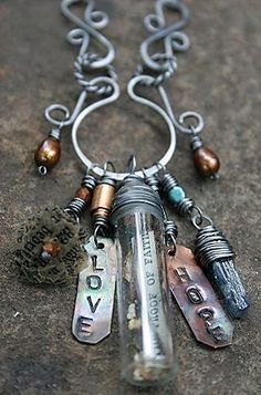 a necklace with some charms hanging from it's sides and words written on them