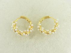 The 925 gold-plated hoop earrings have an outer diameter of approx. 15mm. They are approx. 2.6mm thick. The pearls are a bit larger than 1mm. They have a clip clasp. So simply pull apart to open and press together to close. The earrings come in a pretty jewelry box. The hoops are also available in rose gold in my shop, as are other hoops in different sizes and colors. If you have other wishes please contact me. **Used material** 925 silver hoops gold plated **Size/Dimensions/Weight** see description/Very light **Production method** made for you You can find more jewelry here: https://www.etsy.com/de/shop/GlasschmuckBirgitH Dainty Yellow Gold Hoop Earrings With Pearl, Pearl Huggie Earrings For Anniversary, Pearl Huggie Jewelry For Anniversary, Yellow Gold Pearl Huggie Jewelry, White Dainty Gold-plated Hoop Earrings, White Gold Plated Dainty Hoop Earrings, Dainty Pearl Huggie Hoop Earrings, Dainty Pearl Huggie Earrings Small Hoop, Elegant Adjustable White Gold Huggie Earrings