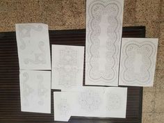 several pieces of paper with designs on them