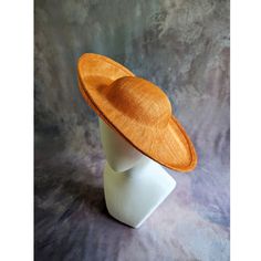 One sinamay straw hatinator base with an upturned brim in pumpkin orange that measures approximately 15" (38cm) in diameter. Crown is approximately 3" (7.6cm) high. The edges of the brim are finished in wired sinamay. The multi-layer stiffened sinamay straw has a great sturdy weave and provides excellent support for your millinery creations. Sinamay is a natural material and you will see occasional beige / brown fibers / striations in the weave. This is not a defect, but is the result of how different natural fibers respond to dye and processing. This is NOT a ready to wear finished hat and will not stay on your head unless you add a head band or elastic to wear. Add embellishments of your choice.  A nice high quality base - I know you'll be pleased! This hat base is listed separately in s Fitted Brown Boater Hat For Kentucky Derby, Adjustable Orange Straw Hat With Curved Brim, Orange Sun Hat With Curved Brim, Orange Curved Brim Sun Hat, Orange Brimmed Straw Hat With Adjustable Fit, Orange Adjustable Brimmed Straw Hat, Adjustable Brimmed Orange Straw Hat, Orange Adjustable Hat With Curved Brim, Adjustable Orange Hat With Curved Brim