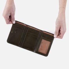 Our take on the iconic trifold wallet, Jill is made for the minimalists and will keep your wallet essentials organized. Jill Trifold Wallet In Polished Leather  Deep Moss MEDIUM WALLET in Moss Green | Hobo® Wallet Essentials, The Minimalists, Cooler Lunch Bag, Nautical Jewelry, Shopping Event, Meaningful Jewelry, Travel Toiletries, Handbag Straps, Trifold Wallet