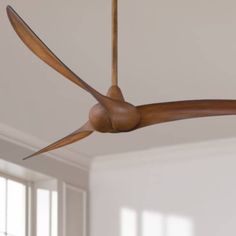 a ceiling fan with wooden blades hanging from the ceiling