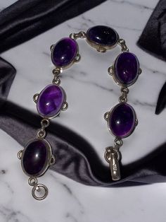 Vintage Designer ND 925 Wide Sterling Silver Black Oval Onyx Link Bracelet MODERNIST * This beautiful 100% Sterling Silver bracelet with six (6) oval purple amethyst stones. Each oval stone measures approximately 19mm x 12mm. * Hallmarked 925 * Weighs 27.6 grams * Measuring approximately 8" long from end to end. * Secure hook clasp * Lovely vintage condition, as shown! Will ship FAST and FREE, fully insured in a gift box : ) Formal Amethyst Oval Cabochon Jewelry, Formal Amethyst Jewelry, Oval Cabochon, Oval Cabochon Bracelets For Formal Occasions, Classic Amethyst Cabochon Jewelry, Classic Oval Cabochon Amethyst Jewelry, Formal Purple Oval Cabochon Jewelry, Classic Amethyst Bracelets, Classic Amethyst Jewelry With Polished Finish, Classic Polished Amethyst Jewelry