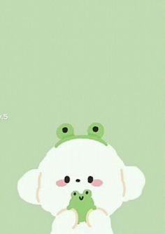 a green and white frog holding a baby frog on top of it's back