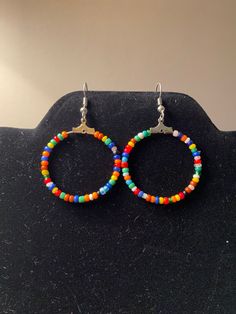 Bohemian styled hoop earrings.  Made with multicolored seed beads.  Multicolored to go with any outfit! * All materials were cleaned and sanitized prior to use and kept in a clean smoke-free environment. Comes packaged in a mesh drawstring bag. Seed Bead Hoop Earrings, Upcycled Earrings, Bead Hoop Earrings, Earrings Beaded, Button Crafts, Beaded Hoop Earrings, Beaded Hoops, Seed Bead Earrings, Earrings Boho