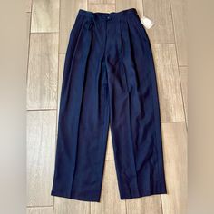 Elevate Your Professional Wardrobe With These Navy Blue Pleated Pants By Christian Dior. Crafted From 100% Worsted Wool, They Provide A Luxurious Feel And Drape Beautifully. The Pants Are Brand New With Tags And Are Perfect For Any Career Wear Occasion. The Pants Are Designed With Women In Mind And Come In Size 14. The Blue Color Adds A Touch Of Sophistication To Your Look And Pairs Well With A Variety Of Tops. The Material Is Soft, Warm, And Comfortable, Making It Perfect For Any Season. Invest Classic Tailored Blue Wide Leg Pants, Blue Classic Wide Leg Formal Pants, Blue Classic Formal Wide Leg Pants, Classic Blue Wide Leg Pants For Formal Occasions, Classic High-waisted Wide Leg Pants In Blue, Navy Formal Bottoms For Spring, Spring Formal Navy Pants, Classic Navy High-waisted Pants, Navy High-waisted Formal Pants