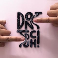 two hands pointing at the word don't touch on a pink background with black letters