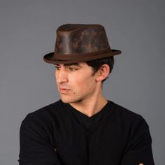 This packable leather fedora that keeps its looks is the piece you need for all ocasions.  This lightweight and durable hat is both tough and cool and makes you the hit of any event!  #fedorahats #hats #leatherfedora Leather Flat Cap Hat For Fall, Leather Flat Cap For Fall, Fitted Fedora With Short Brim For Travel, Casual Brown Leather Hat, Western Style Fitted Fedora For Travel, Casual Leather Hats With Sweatband, Fitted Brown Fedora For Travel, Fitted Brown Panama Hat For Travel, Brown Leather Brimmed Fedora