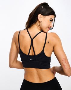 Sportswear by Nike Training Supportive stuff Layered design Scoop neck Strappy, racer back for unrestricted movement Nike logo print on back Pull-on style Sporty Black Sports Bra With Built-in Bra, Functional T-back Sports Bra For Workout, Sporty T-back Crop Top For Workout, Sporty T-back Sports Bra For Gym, Black Sporty T-back Activewear, Black Sports Bra With Built-in Bra And Medium Support, Moisture-wicking T-back Sports Bra With Medium Support, Athleisure T-back Sports Bra For Workout, Moisture-wicking Medium Support T-back Sports Bra