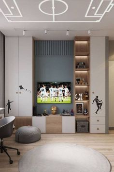 a living room with a large tv on the wall