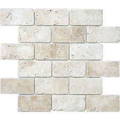 a white brick wall that is made out of several different types of stone tiles, including one