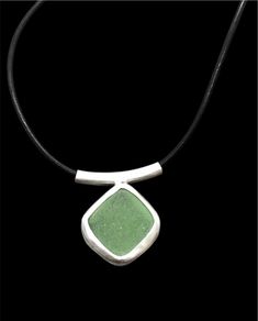 "Handmade sea glass leather cord pendant with a beautifully bright light jade green sea glass nugget. The glass is sourced in Kintyre on the west coast of Scotland.  The naturally tumbled sea glass is set within a fine silver bezel setting, open-backed to allow the light to shine through and enhance the subtle colour of the glass. The pendant is suspended on a sterling silver tube bail on an 16\" black leather lace with sterling silver fittings.  Makes an ideal gift for ladies or girls, wife or Green Pendant Jewelry With Adjustable Cord, Adjustable Green Recycled Glass Necklace, Green Recycled Glass Pendant Jewelry, Minimalist Green Glass Jewelry, Minimalist Green Jewelry With Recycled Glass, Girlfriend Birthday, Christmas Gifts For Him, 21st Birthday Gifts, Sea Glass Necklace