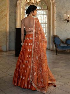 Editor's Note Introducing an exquisite rust heavily hand-embroidered lehenga set, paired with our signature printed organza-based dupatta. The intricate hand embroidery, featuring jaal, motifs,... Blouse Yoke, Printed Organza, 1950’s Fashion, Dress Book, Embroidered Lehenga, Ethnic Outfits, Indian Clothes, Stylish Dress Book, Orange Fabric