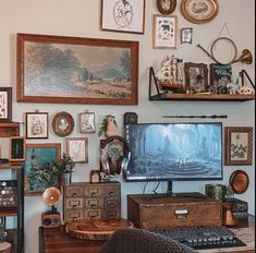 a living room filled with furniture and lots of pictures on the wall above it is a flat screen tv