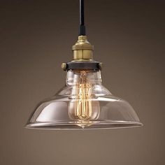 a clear glass light fixture with a black cord hanging from it's end and an open bulb on top