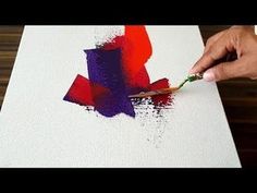 someone is painting with red and purple paint on a white canvas, using a brush