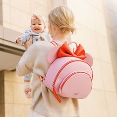 Details Pack up the magic today with our Disney Baby x FP Minnie Anaheim Backpack! This one of kind backpack is perfect for storing all the essentials for mom and baby. Disney Minnie's iconic ears are featured front and center, with small details this is a must-have for any Disney lover. With a spacious main compartment, front pocket, and 6 interior pockets, you can store everything you need for any adventure! Shop the entire Disney Baby x FP Collection here. Features Vegan saffiano leather 100% Pink Minnie Mouse Backpack For Disney Trips, Disney Minnie Mouse Backpack For Travel, Cute Pink Backpack For Disney Trips, Minnie Mouse Travel Backpack, Cute Minnie Mouse Backpack For Daily Use, Playful Minnie Mouse Travel Bag, Minnie Mouse Backpack For Travel And Back To School, Cute Minnie Mouse Backpack, Minnie Mouse Backpack For Everyday Use