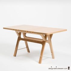 a wooden table sitting on top of a white floor