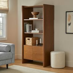 a living room with a couch, chair and bookshelf