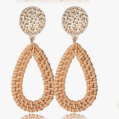 a pair of earrings that are made out of woven material