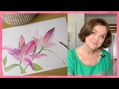 a woman with brown hair and green shirt in front of pink flowers on white paper