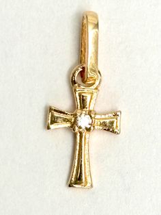 18k solid yellow gold cross pendant  *Metal: 18K Solid Gold *Stones : cubic zirconia  *Metal weight: 0.65 grams *Total height : 16 mm  *Total width: 6 mm Handmade made in Colombia  This high-quality gold pendant is handmade in highest quality craftsmanship. - A good investment since 18k solid gold items hardly go down in value and in fact would go up in value long term. * It's a very flattering minimalist pendant perfect for any occasion. Packing Each order will be beautifully packaged for gift giving in a jewelry box. Antique Yellow Gold Cross Pendant Necklace, Engraved Yellow Gold Cross Pendant, Cross Pendant Necklace Woman, Hallmarked Yellow Gold Cross Pendant Jewelry, Yellow Gold Hallmarked Cross Pendant, Tarnish-resistant Yellow Gold Cross Pendant, Gold Items, Minimalist Pendant, Gold Cross Pendant