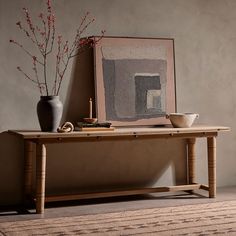 a table with some vases and a painting on it