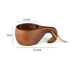 a wooden bowl that is shaped to look like an elephant's tail, with measurements for