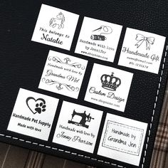 several labels on a piece of black leather with white stitching and some type of lettering