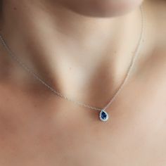 Indulge in tranquil beauty with this Pear Shaped Blue Sapphire and Diamond Halo Necklace. Perfect for gifting to a loved one (or yourself - no judgment here!) wear with our matching bracelet, ring, and earrings. Natural Blue Sapphire: 0.40cts Natural Diamonds: 0.05ctw 18K White Gold Length: 16 Inches Diamond Drop Jewelry With Polished Finish, Elegant Sapphire Necklace With Hand-set Details, Luxury Pear-shaped Sapphire Jewelry, Fine Jewelry Sapphire Drop Necklace, Luxury Sapphire Drop Jewelry, Exquisite Hand Set Pear-shaped Jewelry, Formal Teardrop Jewelry With Polished Finish, Blue Cubic Zirconia Jewelry Gift, Exquisite Blue Teardrop Jewelry