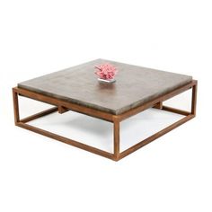 a square coffee table with a flower on top