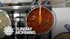 a person stirring food in a pot on the stove